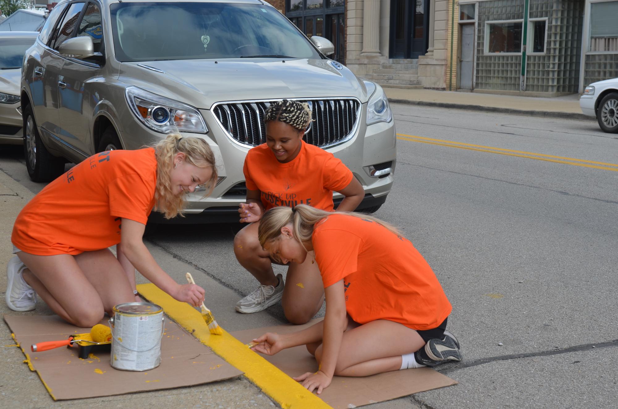 Poseyville students painting street curb